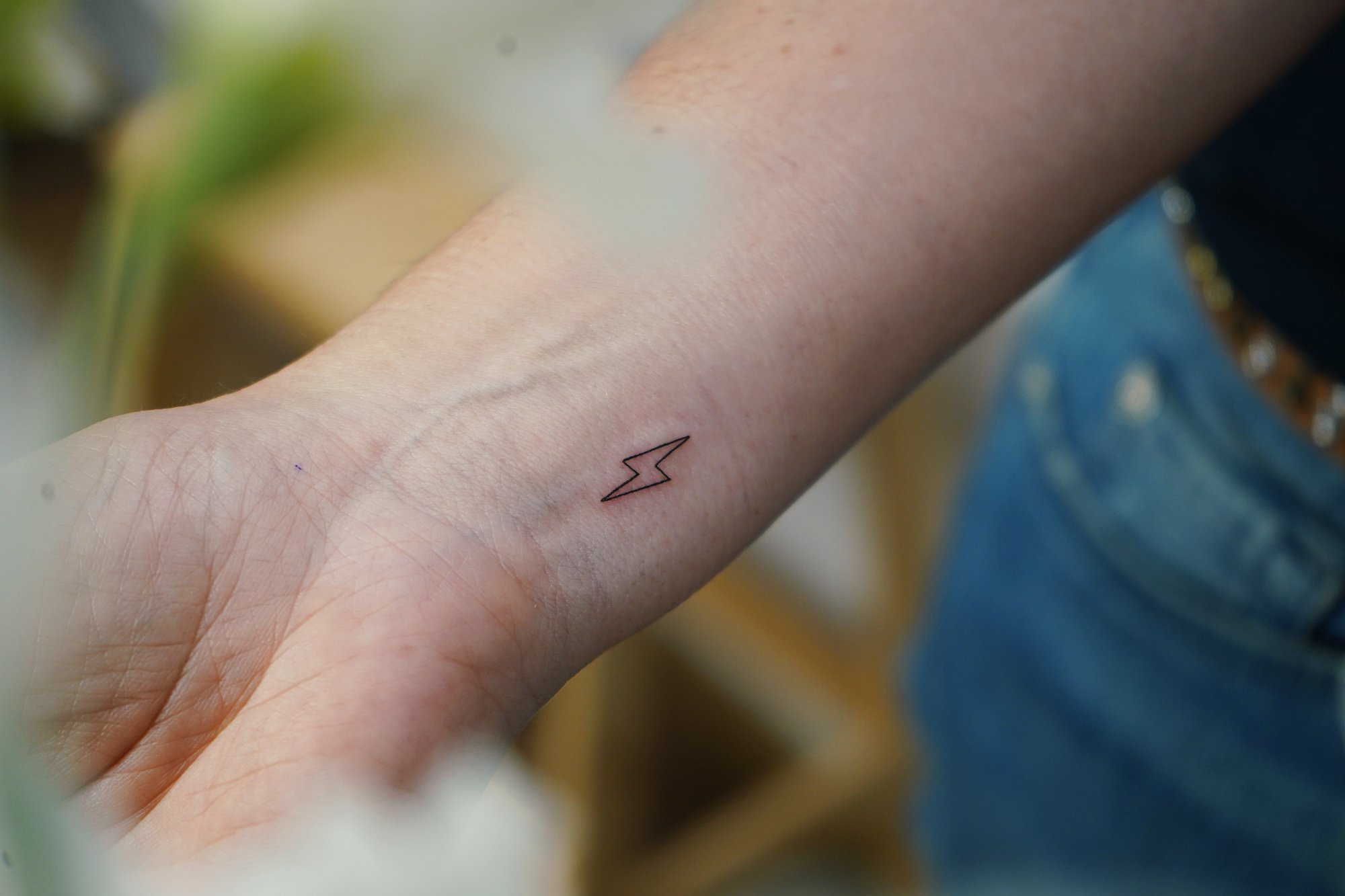 Tatuaje de rayo en muneca, línea fina