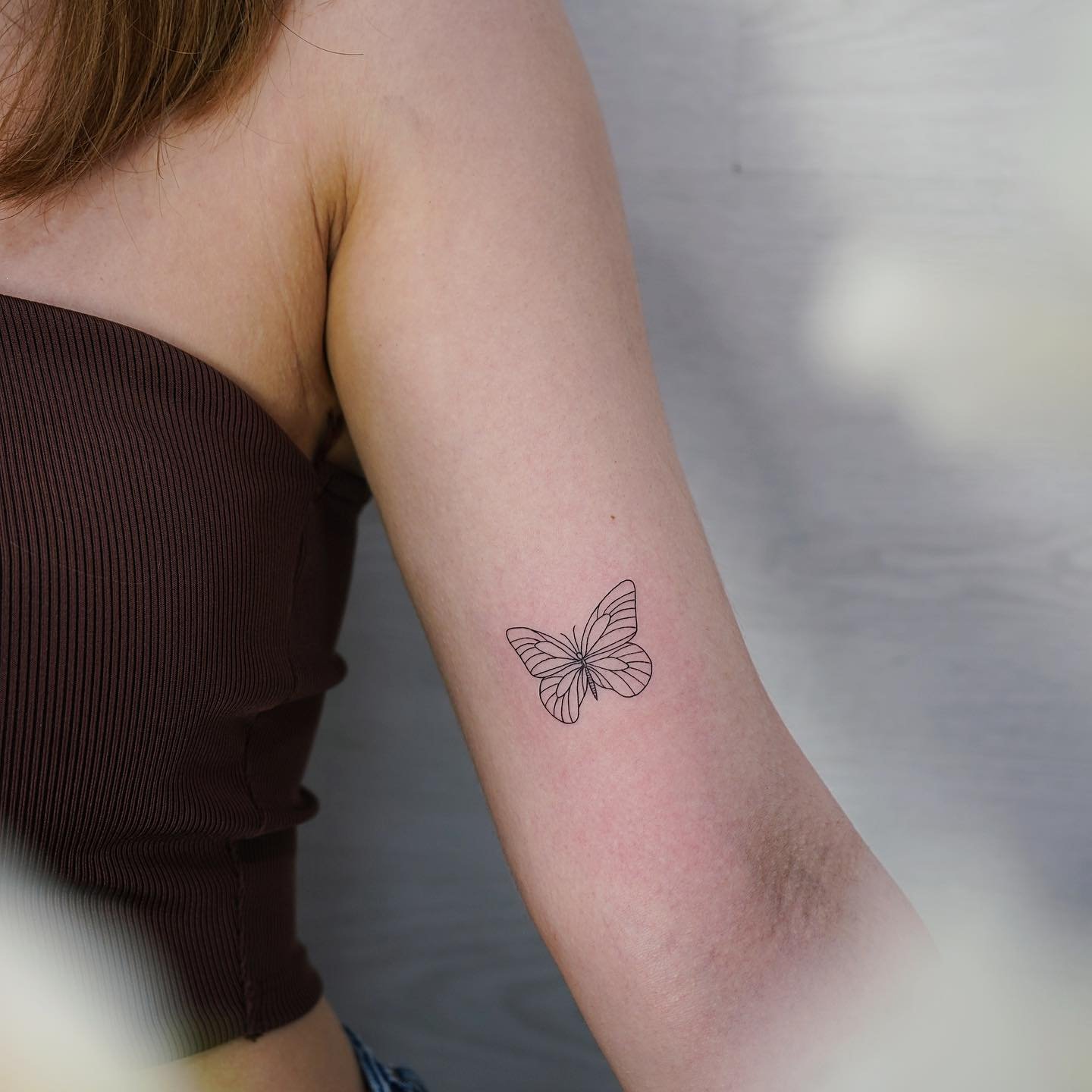 Tatuaje de mariposa en antebrazo, línea fina Sinkply Madrid