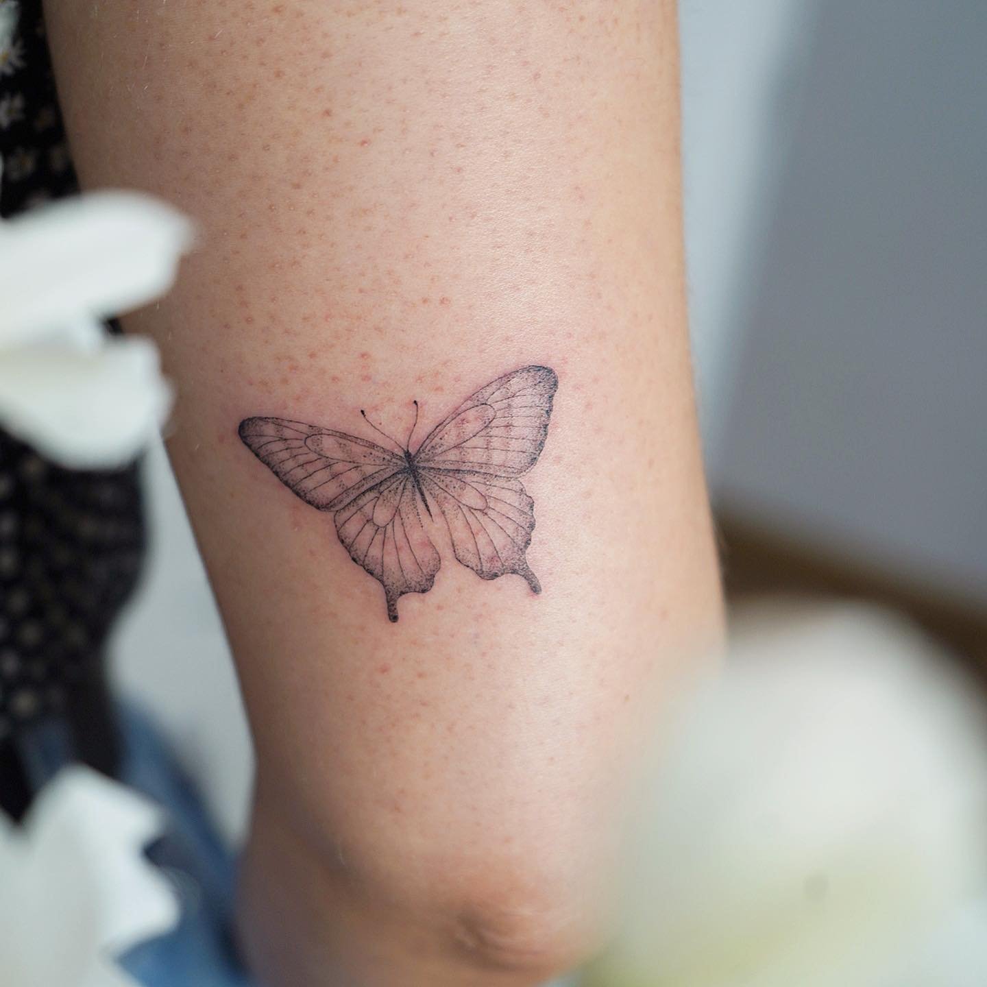 Tatuaje de mariposa en antebrazo, línea fina Sinkply Madrid