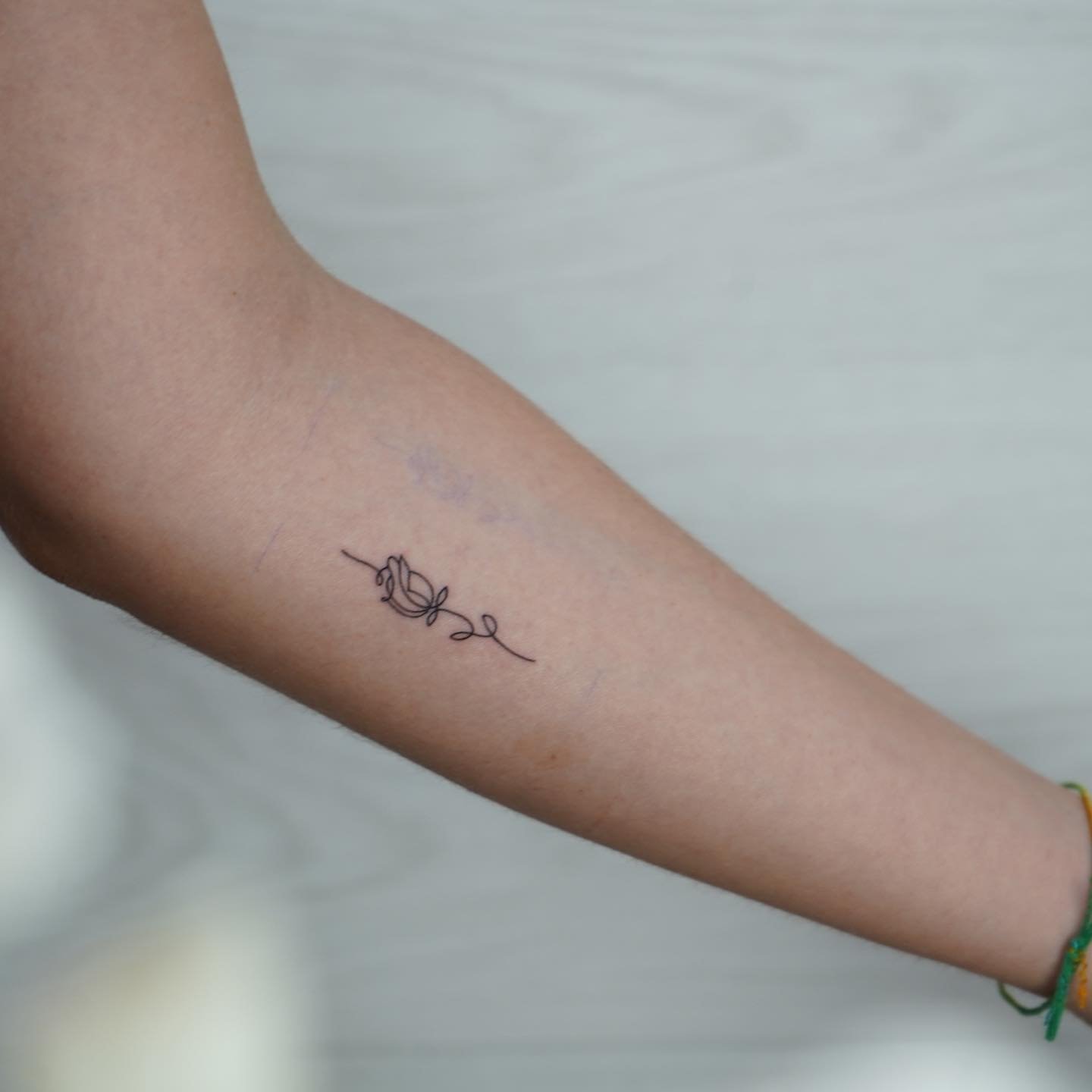 Tatuaje de flor en antebrazo, línea fina Sinkply Madrid