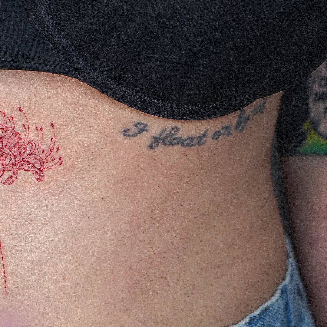 Tatuaje de flor en costilla, línea fina Sinkply Madrid