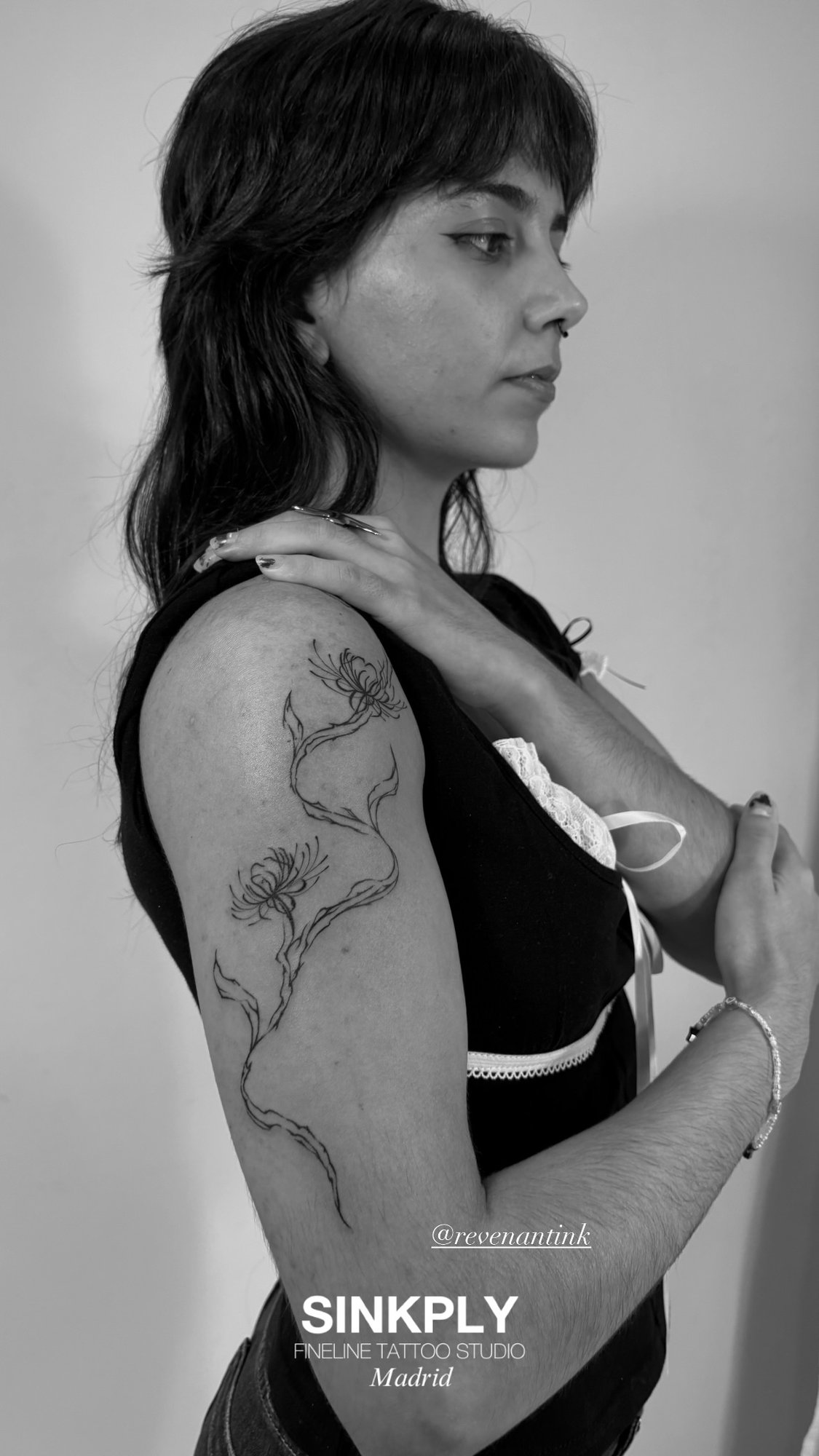 Tatuaje de flores con tallo fineline en brazo, línea fina