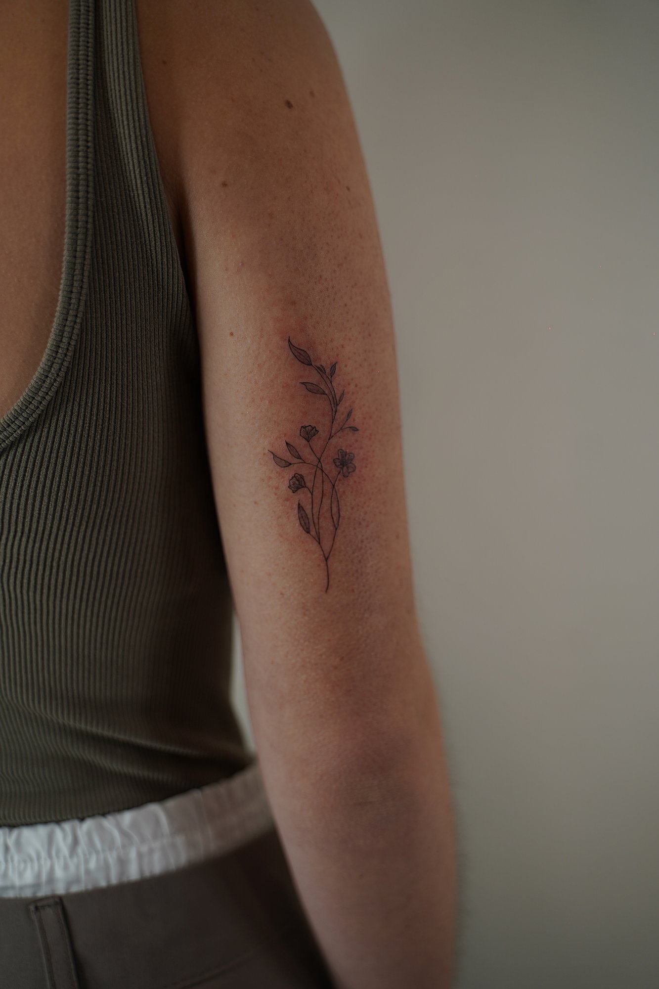 Tatuaje de ramita flores en zona desconocida, línea fina
