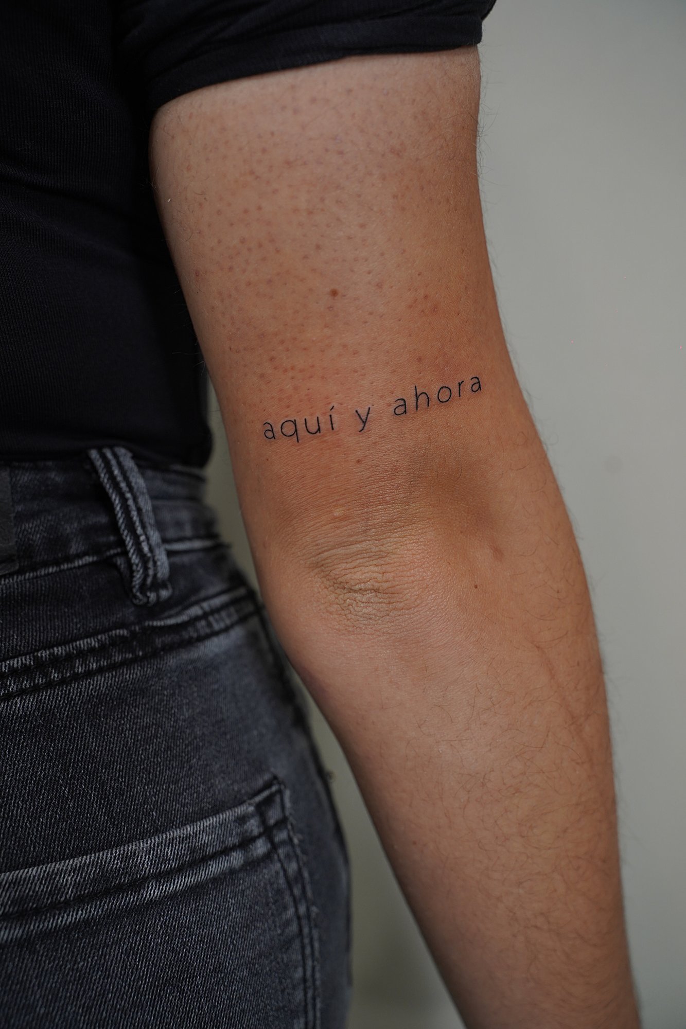 Tatuaje de frase en brazo, línea fina