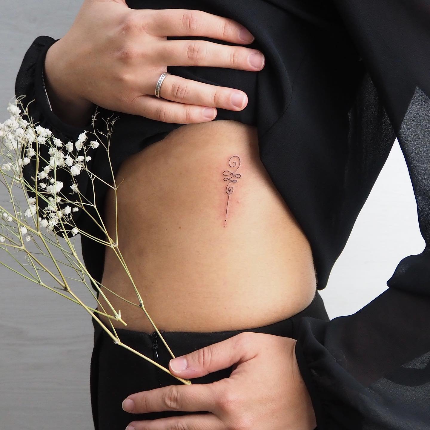 Tatuaje de frase en costilla, línea fina Sinkply Madrid