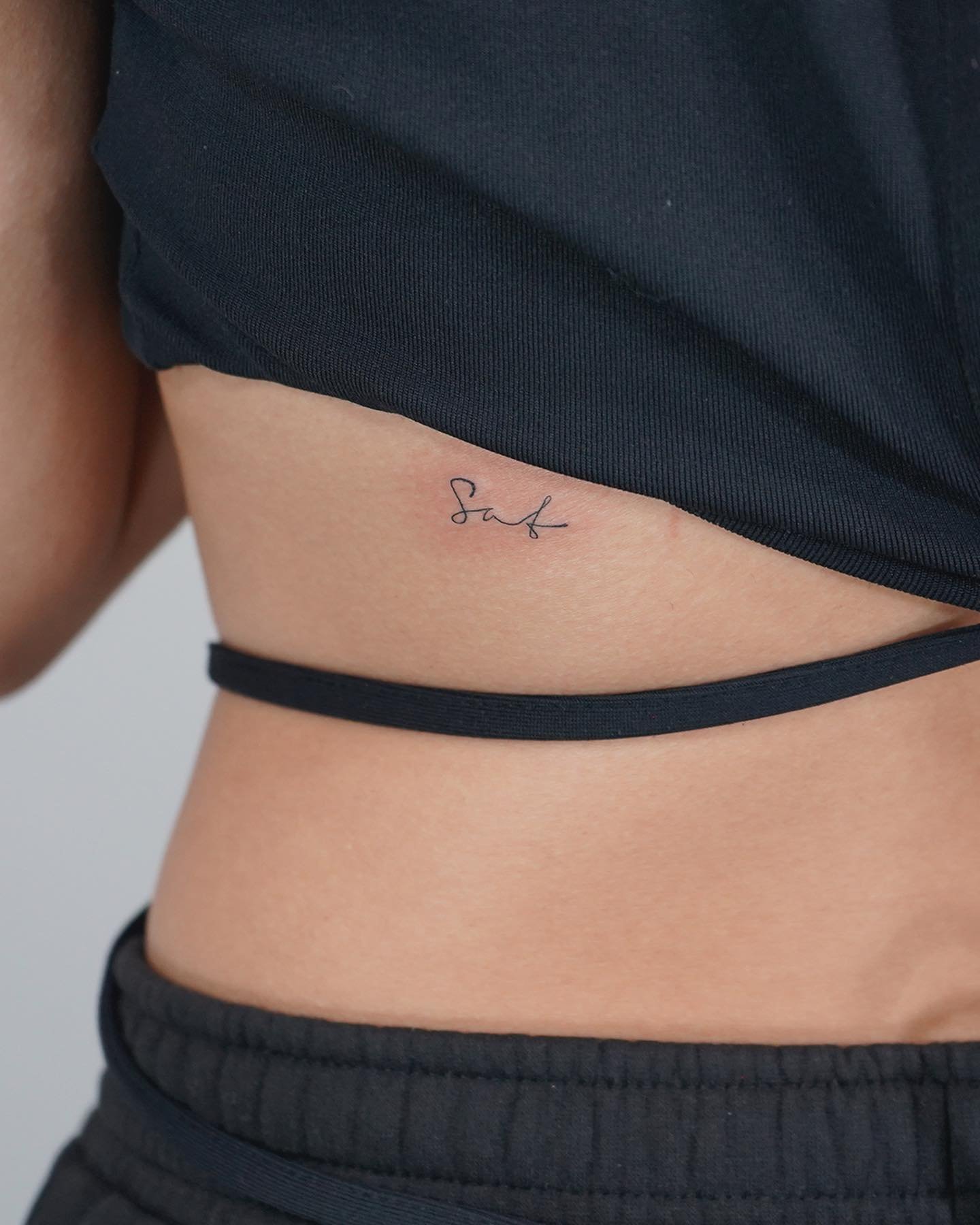 Tatuaje de frase en costilla, línea fina Sinkply Madrid