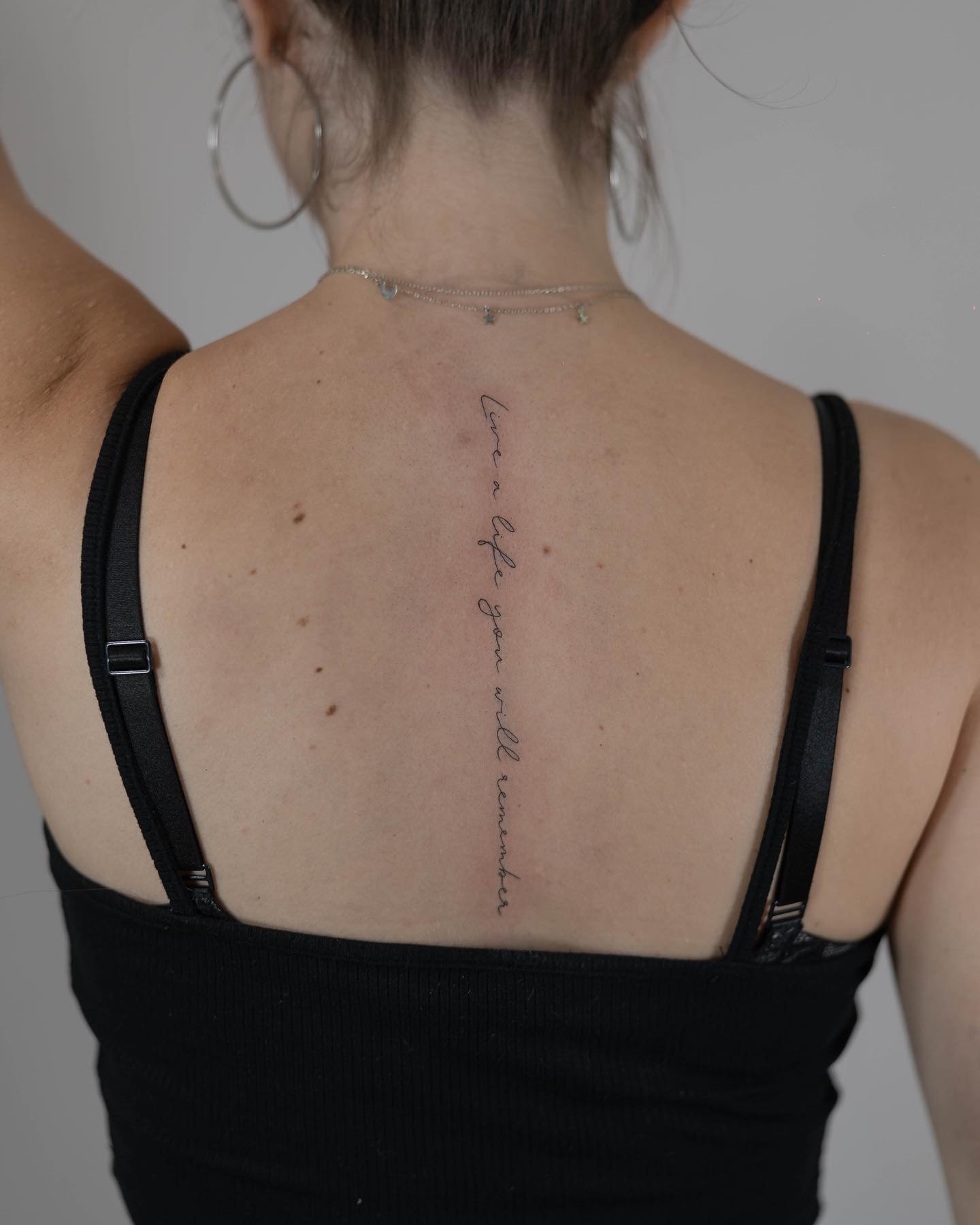 Tatuaje de frase en espalda, línea fina Sinkply Madrid