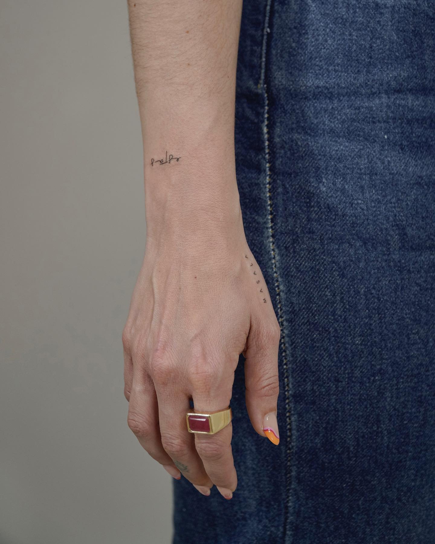 Tatuaje de frase en mano, línea fina Sinkply Madrid
