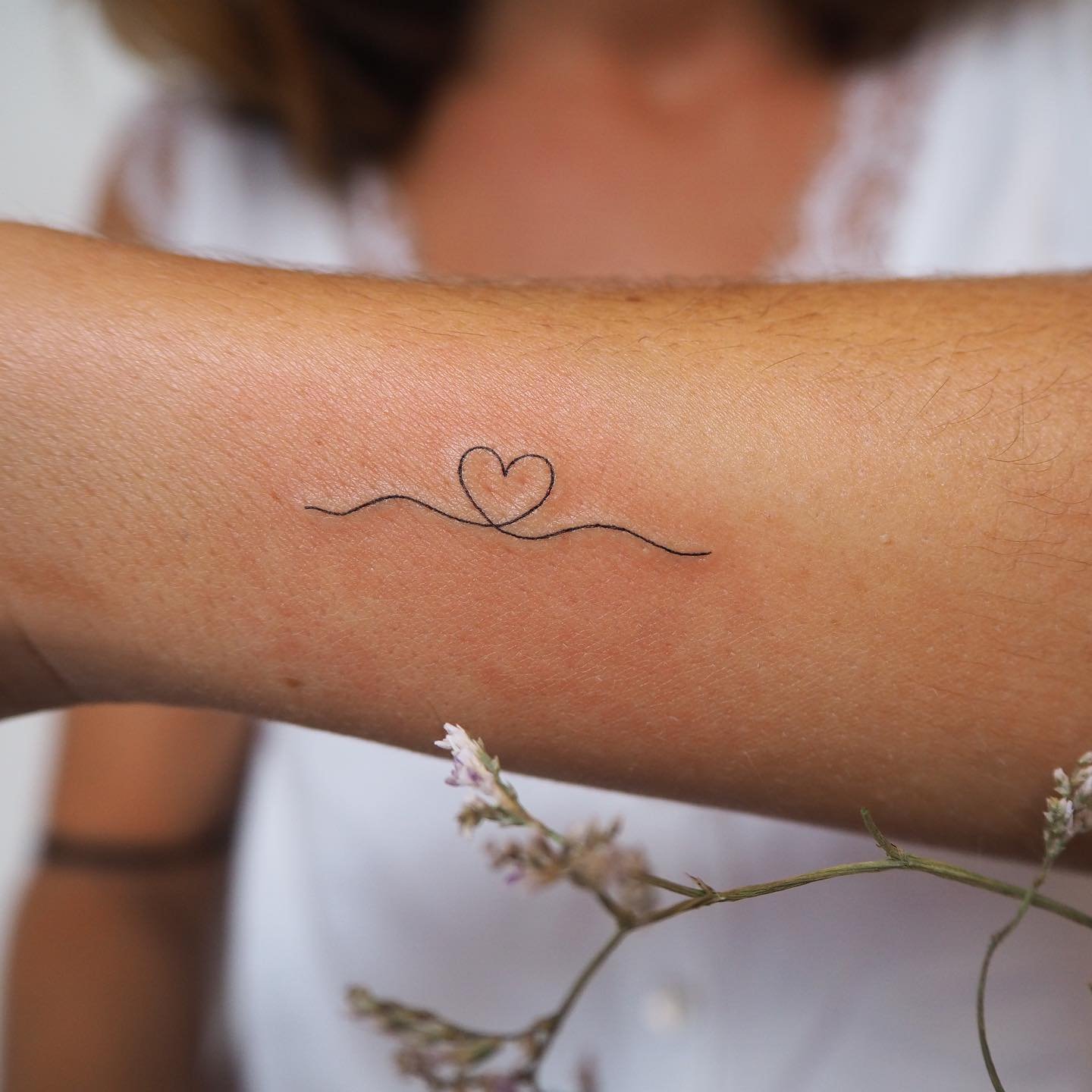 Tatuaje de corazon en antebrazo, línea fina Sinkply Madrid