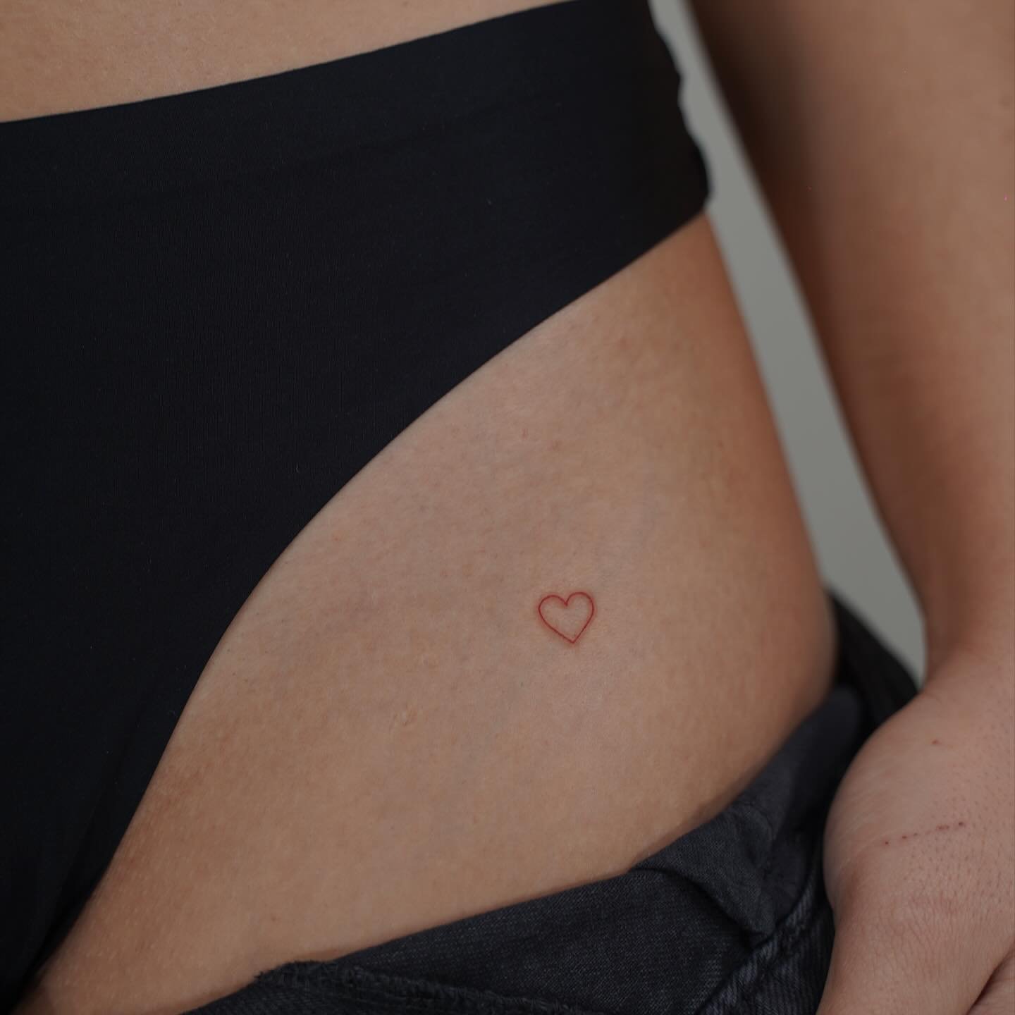 Tatuaje de corazon en muslo, línea fina Sinkply Madrid